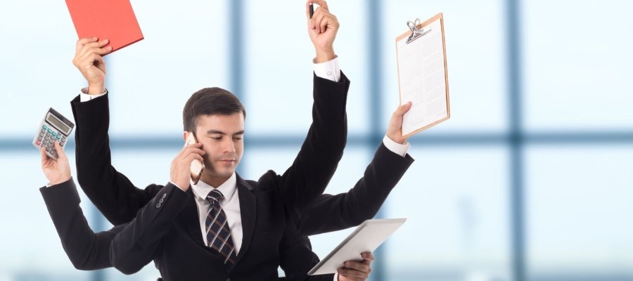 a man with many arms holding several clipboards while talking on a phone, symbolizing the act of juggling leads